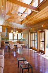Natural materials and landscape-based shading strategies give richness and texture to the simple passive solar volumes.
