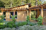Connecting halls are glazed to create the sensative of moving outdoors between each of the strawbale structures.
