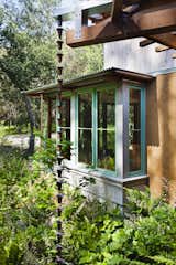 From the outside, the music nook emerges from the great room volume, with views to the redwood grove.