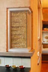 A truth window shows the straw bale insulation of the main building structure.