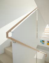 Stair runs are divided by thin steel panel