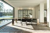 Dining Room, Rug Floor, Wall Lighting, Table, Medium Hardwood Floor, and Chair  Photos from Prestigious Modern Villa in Belgium Asks $6.8M