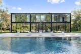 Exterior, Glass Siding Material, House Building Type, and Flat RoofLine The two levels of the home are connected by two independent staircases.  Photo 21 of 22 in 21 Finely Finessed Getaways in the Hamptons and Montauk from Glass and Steel Abode in New York Asks $5M