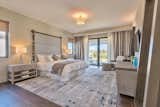 Bedroom, Dresser, Ceiling Lighting, Night Stands, Table Lighting, Medium Hardwood Floor, Rug Floor, and Bed  Photo 4 of 6 in Contemporary Villas Overlooking Bermuda's South Shore Now For Sale by Sotheby’s International Realty