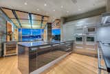 Kitchen, Recessed Lighting, Light Hardwood Floor, Undermount Sink, Wall Oven, Range Hood, and Wine Cooler  Photo 3 of 5 in A Striking Waterfront Estate in Canada Is Now Available by Sotheby’s International Realty