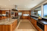 Kitchen, Rug Floor, Refrigerator, Dishwasher, Wall Oven, Undermount Sink, Range, Wood Cabinet, Recessed Lighting, Microwave, Metal Backsplashe, and Range Hood  Photo 2 of 5 in A Certified Paradise in Hawaii Asks $5.99M by Sotheby’s International Realty