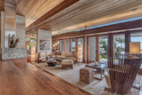 Living Room, Medium Hardwood Floor, Ottomans, Rug Floor, Coffee Tables, End Tables, Chair, Sofa, and Table Lighting  Photo 2 of 5 in A Sanctuary in Southern California Asks $6M by Sotheby’s International Realty