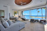 Living Room, Recessed Lighting, Ottomans, Ceiling Lighting, Chair, Ceramic Tile Floor, Coffee Tables, Sectional, and Sofa  Photo 7 of 11 in This Breathtaking Beachfront Estate in Mexico Asks 19.5M by Sotheby’s International Realty