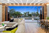 Living Room, Sectional, Medium Hardwood Floor, Chair, and Coffee Tables  Photo 1 of 6 in A Private Waterfront Oasis in Queensland, Australia Asks $1.24M by Sotheby’s International Realty