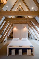 Giant wooden roof beams in the attic suite add to the peaceful and minimalist space.