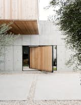 A pivoting door, also made of larch, provides a shortcut to enter the structure as an alternative to the main courtyard entrance.