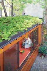 When architect Paul Bernier and lawyer Joëlle Thibault sought to expand their home in the Plateau Mont-Royal neighborhood of Montreal, they designed two additions: a new office on the top level and a backyard playroom with a green roof. The single-story addition to the row house adds square footage without eating up too much outdoor space. The green roof also helps makes up for lost garden beds, while creating attractive, leafy views from the second and third floors.