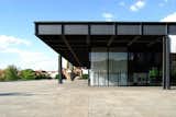 The Neue National Galerie (New National Gallery) by Ludwig Mies van der Rohe midcentury style building with glass and steel exteriors and steel roof with flat roofline