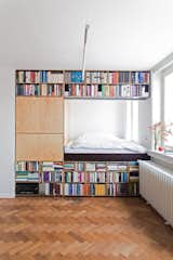 This renovation for a writer in Prague by BY Architects has slotted the bed behind a massive bookshelf in order to meet spatial requirements.&nbsp;