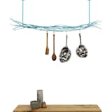 This modern pot rack from Merkled Studio is made from salvaged steel loom ends collected from a weaving company located only 10 blocks from the designer's studio. Able to hold even the heaviest cast-iron skillet, each organic piece has also been powder-coated for durability.