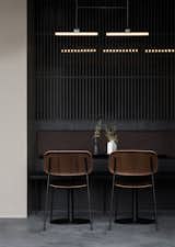 "With an interior design defined by an array of stone, wood, and metal, the materials are all natural and have deliberately been altered in order to create dark and industrial surfaces that match the mood of the place," explains the architects.