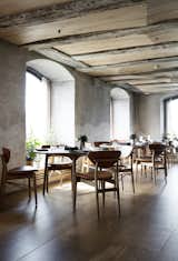 The ceiling is alternately composed of the original ceiling beams and new, sculpted wooden planks, which are embedded with brass details that reflect micro spots of light.  Photo 5 of 10 in Snøhetta Designs the Interiors of Barr, the Noma Group’s New  Copenhagen Restaurant