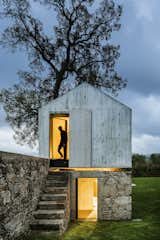 AZO Sequeira Arquitectos Associados transformed this derelict stone and wood backyard dovecoat located in Soutelo, Portugal, into a magical and minimalist concrete children's playhouse complete with a separate level for showers to compliment their client's backyard swimming pool.