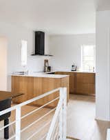For this home in Copenhagen, this design by Henning Larsen Architects was customized in oak veneer with a copper strip and is complemented by a white Corian countertop.