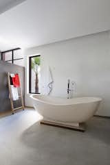 Bath Room, Freestanding Tub, Concrete Floor, Concrete Wall, and Soaking Tub  Photo 10 of 12 in Stay in a Chic and Modern Moroccan Villa Near the Medina of Marrakech