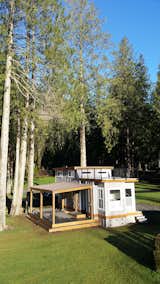 The Flat Roof Caboose design features a loft that can accommodate two beds. Windows give the loft area an open-air feel with an abundance of light. The front of the cabin opens to a private deck. Exteriors are covered with a mix of metal and wood-tone siding for a contemporary finish.&nbsp;