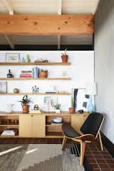 Living Room, Chair, Shelves, Storage, Rug Floor, Table Lighting, and Terra-cotta Tile Floor  Photos from A Hudson Valley Home’s Renovation Is Guided by Its Best Midcentury Feature