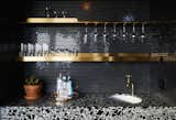 Black was a natural choice when it came to updating an already existing wet bar. The brass shelf was laser-cut from thick brass sheet--designed with a simple geometry as a nod to a classic bar.