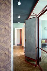 An initial partition creates a relationship between the entrance and living room, preserving the original design of the parquet flooring with inlaid "squares."&nbsp;