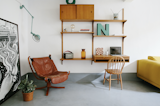 One of the spaces holds a midcentury, wall-mounted storage system and desk.&nbsp;