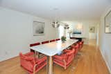 Dining Room, Table, Chair, Medium Hardwood Floor, Pendant Lighting, and Ceiling Lighting The dining room overlooks the front yard.  Photo 6 of 14 in An Airy Toronto Estate For Sale Boasts Excellent Feng Shui
