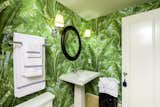 Bath Room, Pedestal Sink, and Wall Lighting Fernando Wong’s master bath brings the outdoors in with bold wallpaper.  Photos from A Landscape Designer's 5 Main Tips for Bringing the Outdoors in
