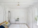 Bedroom, Bed, Light Hardwood, Ceiling, Storage, and Wardrobe  Bedroom Storage Ceiling Wardrobe Light Hardwood Photos from A Hamptons Beach Retreat Gets a Scandinavian-Style Makeover