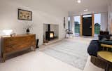Living, Wood Burning, Light Hardwood, Rug, Storage, End Tables, Sofa, Chair, Table, and Recessed A sitting area with a stove creates a cozy sense of  Living Light Hardwood Rug Wood Burning Recessed Photos from A Scandinavian-Style Pavilion in England Is Listed For $2.1M