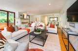 Living, Standard Layout, Sofa, Chair, Medium Hardwood, Coffee Tables, Console Tables, Rug, and Recessed The open plan living room has great space for entertaining.  Living Medium Hardwood Recessed Console Tables Photos from Anna Faris Lists Her Midcentury Abode in the Hollywood Hills For $2.5M