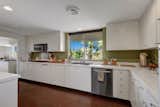 The kitchen and prep kitchen feature stainless-steel appliances, commercial fixtures, and cork floors.&nbsp;
