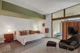 The guest bedroom looks out on the pool area.