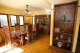 Dining Room, Table, Storage, Chair, Medium Hardwood Floor, Ceiling Lighting, and Wall Lighting The dining room.  Photo 6 of 10 in A Rare Lloyd Wright Prairie Home in L.A. Wants $1.35M