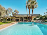 Exterior, House Building Type, Mid-Century Building Type, and Flat RoofLine The large L-shaped estate looks out on a large pool and a luxurious outdoor entertaining area.  Photo 11 of 16 in A Luminous Palm Springs Midcentury Asks $3.35M