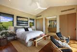 Bedroom, Bed, Bench, Medium Hardwood Floor, Ceiling Lighting, Chair, and Night Stands The bedroom features  Photo 8 of 29 in Hawaii Ideas by Samuel Choi from A Breezy Hawaiian Residence by Olson Kundig Hits the Market at $6.95M