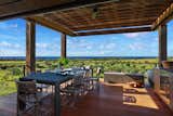 Outdoor, Back Yard, and Large Patio, Porch, Deck A covered exterior dining area around the pool.  Photo 9 of 14 in A Breezy Hawaiian Residence by Olson Kundig Hits the Market at $6.95M