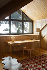 A minimalist desk looks out on the alpine scenery in the master bedroom.&nbsp;