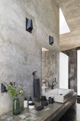 Bath Room, Vessel Sink, Concrete Floor, Concrete Counter, Wall Lighting, and Concrete Wall One of the bathrooms.  Photo 6 of 10 in A Commanding Mexican Home of Stone and Concrete Is For Sale