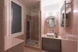 Bath, Wall, Porcelain Tile, Enclosed, Porcelain Tile, Vessel, Tile, and Corner The guest bathroom picks up on the pink lacquered them that runs throughout the apartment.  Bath Wall Tile Corner Photos from Before & After: An Ancient Barcelona Apartment Gets a Colorful, Chic Makeover
