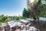 Outdoor, Side Yard, Raised Planters, Small Patio, Porch, Deck, Decking Patio, Porch, Deck, and Trees A shaded lounging area by the pool.  Photo 11 of 15 in A Renovated Harry Gesner–Designed Midcentury in L.A. Wants $9.4M