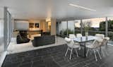 Bertram retained Neutra’s open floor plan and minimalist aesthetic—soft white tones contrast with the dark slate geometric flooring.