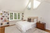 An additional bedroom with built-in bookshelves.