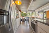 Kitchen, White Cabinet, Refrigerator, Cooktops, Wall Oven, Pendant Lighting, Drop In Sink, and Glass Tile Backsplashe Appliances have been updated in keeping with the design.  Photo 8 of 21 in An Elegant Eichler Hits the Market at $1.15M in Northern California