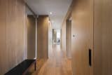 Wood-paneled walls concealing storage line the corridor and play off the unit's oak wood flooring.&nbsp;