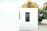 The home's whitewashed exterior references Greek island architecture.