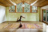 The original garage had been previously converted into a home office space. However, with the addition of wood ceilings, and sliding doors leading out to the garden it was transformed into a yoga studio for the homeowner where she now teaches and practices daily.